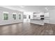 Bright, open-concept living room and kitchen with hardwood floors and ample natural light from large windows at 5208 Admirals Lndg, Lancaster, SC 29720