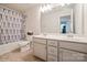 Well-lit bathroom with a double vanity, a shower-tub combination, and a large mirror, designed for convenience at 5391 Orchid Bloom Dr, Indian Land, SC 29707