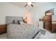 Comfortable bedroom with plush bedding, a ceiling fan, and ample natural light, creating a relaxing retreat at 5391 Orchid Bloom Dr, Indian Land, SC 29707