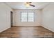 Inviting bedroom featuring wood floors, neutral walls, and a ceiling fan, offering a peaceful retreat at 5391 Orchid Bloom Dr, Indian Land, SC 29707