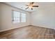 Bright bedroom with wood flooring, neutral walls, and large windows, creating a modern and inviting space at 5391 Orchid Bloom Dr, Indian Land, SC 29707
