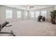 Spacious bonus room with many windows providing natural light, perfect for a home office or recreation area at 5391 Orchid Bloom Dr, Indian Land, SC 29707