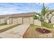 Townhome exterior with two-car garage and driveway and a freshly landscaped lawn at 5391 Orchid Bloom Dr, Indian Land, SC 29707