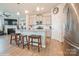 Spacious kitchen with stainless steel appliances, breakfast bar, and access to the living room at 5391 Orchid Bloom Dr, Indian Land, SC 29707