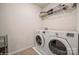 Convenient laundry room featuring a washer, dryer, and ample shelving for storage, ensuring efficient laundry management at 5391 Orchid Bloom Dr, Indian Land, SC 29707