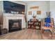 Inviting living room features a fireplace, TV, and a wooden rocking chair adorned with an American flag pillow at 5391 Orchid Bloom Dr, Indian Land, SC 29707