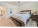 Spacious main bedroom with a large bed and hardwood floors at 5391 Orchid Bloom Dr, Indian Land, SC 29707