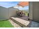 Relaxing patio with seating, sun umbrella and artificial grass at 5391 Orchid Bloom Dr, Indian Land, SC 29707