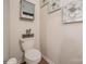 Charming powder room with a toilet, unique storage cabinet, and decorative wall art at 5391 Orchid Bloom Dr, Indian Land, SC 29707