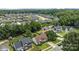 Expansive aerial view of a residential neighborhood featuring tree-lined streets and well-maintained homes, showing neighborhood layout at 5508 Burning Ridge Dr, Monroe, NC 28110