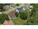 Aerial view showcasing backyard with patio set, grill, and lush greenery, capturing the essence of outdoor living and neighborhood at 5508 Burning Ridge Dr, Monroe, NC 28110