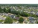 An aerial view of a residential neighborhood with lush green landscaping and well-maintained homes at 5508 Burning Ridge Dr, Monroe, NC 28110