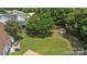 Expansive backyard featuring a storage shed and lush green space, bordered by fencing and mature trees for added privacy at 5508 Burning Ridge Dr, Monroe, NC 28110