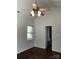 Bedroom with hardwood floors, ceiling fan, window and entrance to bathroom at 5508 Burning Ridge Dr, Monroe, NC 28110