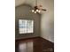 Bright bedroom with hardwood floors, ceiling fan, and a window for natural light at 5508 Burning Ridge Dr, Monroe, NC 28110