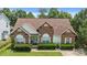 Charming brick home with a well-manicured lawn and mature landscaping offers great curb appeal at 5508 Burning Ridge Dr, Monroe, NC 28110
