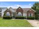 Well-maintained brick home featuring arched windows and lush green lawn in a serene neighborhood at 5508 Burning Ridge Dr, Monroe, NC 28110