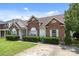 Traditional brick home with manicured hedges and ample parking space on a sunny day at 5508 Burning Ridge Dr, Monroe, NC 28110