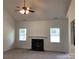 Bright living room featuring a cozy fireplace, neutral carpet, and ample natural light through large windows at 5508 Burning Ridge Dr, Monroe, NC 28110
