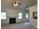 Spacious living room with fireplace, ceiling fan and large windows offers cozy relaxation at 5508 Burning Ridge Dr, Monroe, NC 28110