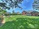 Spacious backyard with lush, patterned lawn, brick house, deck, and gazebo with patio seating at 5921 Meadowmere Dr, Monroe, NC 28110