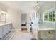 Stylish bathroom features a soaking tub, glass enclosed shower, and neutral paint at 5921 Meadowmere Dr, Monroe, NC 28110