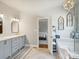 Chic bathroom features soaking tub, chandelier, and modern vanity at 5921 Meadowmere Dr, Monroe, NC 28110