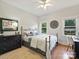 Cozy bedroom featuring hardwood floors, natural light, and stylish decor at 5921 Meadowmere Dr, Monroe, NC 28110