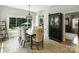 Dining area featuring a wood table, tufted chairs, and a view of the backyard at 5921 Meadowmere Dr, Monroe, NC 28110