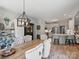 Bright dining area featuring a wooden table, tufted chairs, and a stylish chandelier at 5921 Meadowmere Dr, Monroe, NC 28110