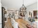 Bright dining area with wood table, tufted chairs, and seamless flow into the modern kitchen at 5921 Meadowmere Dr, Monroe, NC 28110