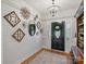 Inviting foyer featuring wood floors, decorative mirrors, shiplap accent wall, and stylish chandelier at 5921 Meadowmere Dr, Monroe, NC 28110