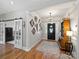 Inviting foyer featuring wood floors, decorative mirrors, shiplap accent wall, and stylish chandelier at 5921 Meadowmere Dr, Monroe, NC 28110