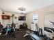Spacious home gym with workout equipment, a wall mounted TV, and weights for a complete fitness experience at 5921 Meadowmere Dr, Monroe, NC 28110