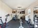 Spacious home gym with various workout equipment, weights, TV and mirror for a great fitness space at 5921 Meadowmere Dr, Monroe, NC 28110