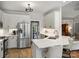 Modern kitchen with stainless steel refrigerator, white cabinets and a stylish breakfast bar at 5921 Meadowmere Dr, Monroe, NC 28110