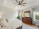 Bright main bedroom boasts tray ceilings, fan, natural light, and beautiful wood floors at 5921 Meadowmere Dr, Monroe, NC 28110