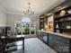 Home office featuring a built-in bar with a beverage cooler and a large window at 5921 Meadowmere Dr, Monroe, NC 28110
