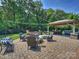 The backyard features an outdoor patio with a gazebo, seating, a fire pit, and string lights for ambiance at 5921 Meadowmere Dr, Monroe, NC 28110