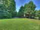 Spacious backyard featuring a fire pit and lush landscaping at 6314 Saint Stephen Ln, Charlotte, NC 28210