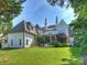 Beautiful backyard view of the home featuring a well manicured lawn at 6314 Saint Stephen Ln, Charlotte, NC 28210