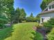 Expansive backyard featuring lush lawn, mature trees, and meticulously maintained landscaping at 6314 Saint Stephen Ln, Charlotte, NC 28210