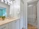 Bright bathroom featuring a granite countertop, white cabinets, neutral walls, and shower with white curtain at 6314 Saint Stephen Ln, Charlotte, NC 28210