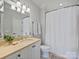 Bright bathroom featuring a granite countertop, white cabinets, neutral walls, and shower with white curtain at 6314 Saint Stephen Ln, Charlotte, NC 28210