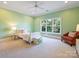 Bright bedroom with a large window, bed, chair, and light green walls at 6314 Saint Stephen Ln, Charlotte, NC 28210