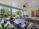 Inviting covered patio with comfortable seating, ceiling fan, grill, and views of the landscaped backyard at 6314 Saint Stephen Ln, Charlotte, NC 28210