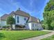 Charming home exterior showcasing lush landscaping, manicured lawn, and an attached garage at 6314 Saint Stephen Ln, Charlotte, NC 28210
