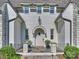 Charming front entrance featuring a stone pathway, gray painted brick, and decorative plantings at 6314 Saint Stephen Ln, Charlotte, NC 28210