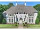 Striking white painted brick home with well manicured lawn and stone pathway to front door at 6314 Saint Stephen Ln, Charlotte, NC 28210