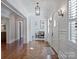 Charming hallway with hardwood floors, designer wallpaper, and an arched doorway to the dining room at 6314 Saint Stephen Ln, Charlotte, NC 28210